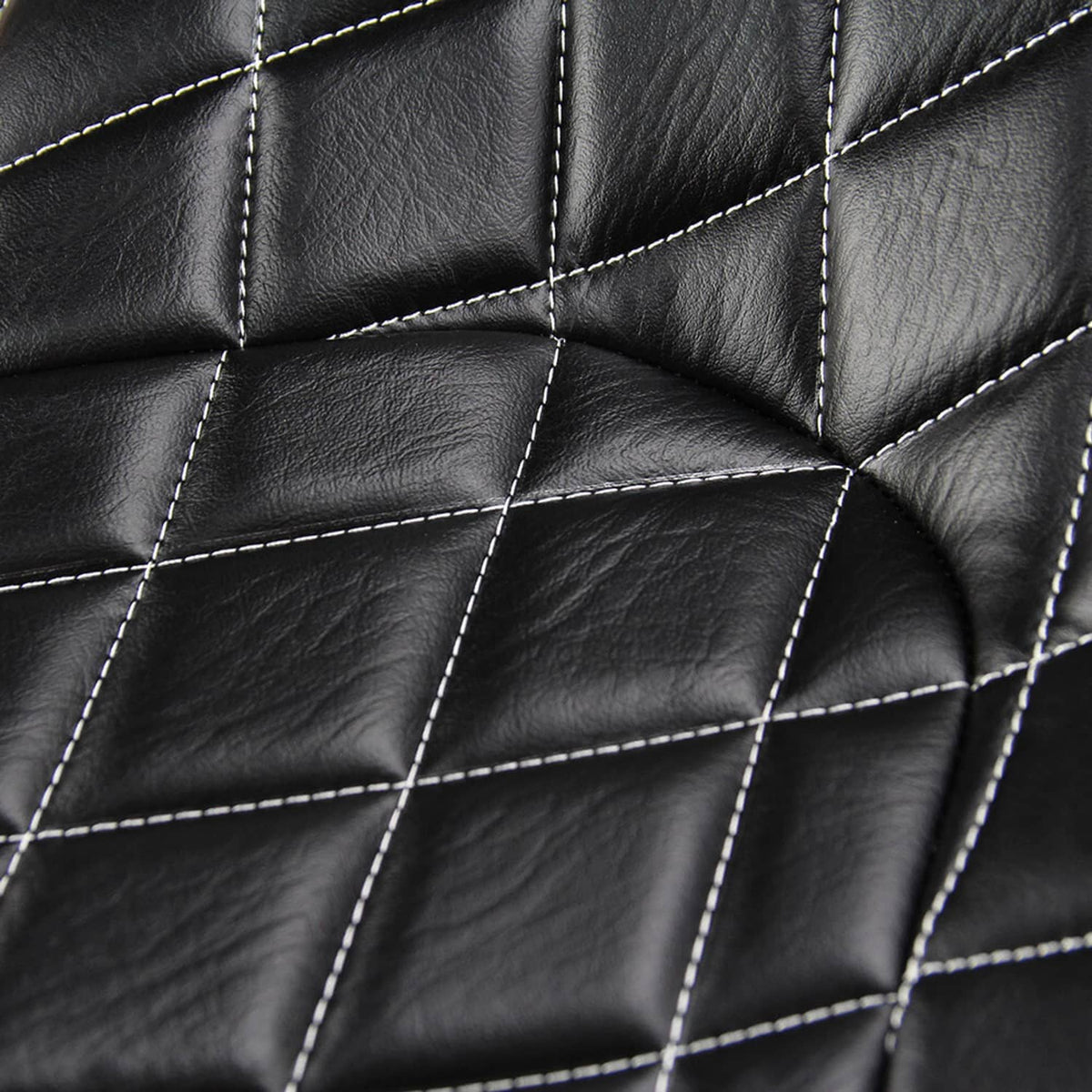 Close-up of black quilted seat cushion upholstery with white contrast stitching