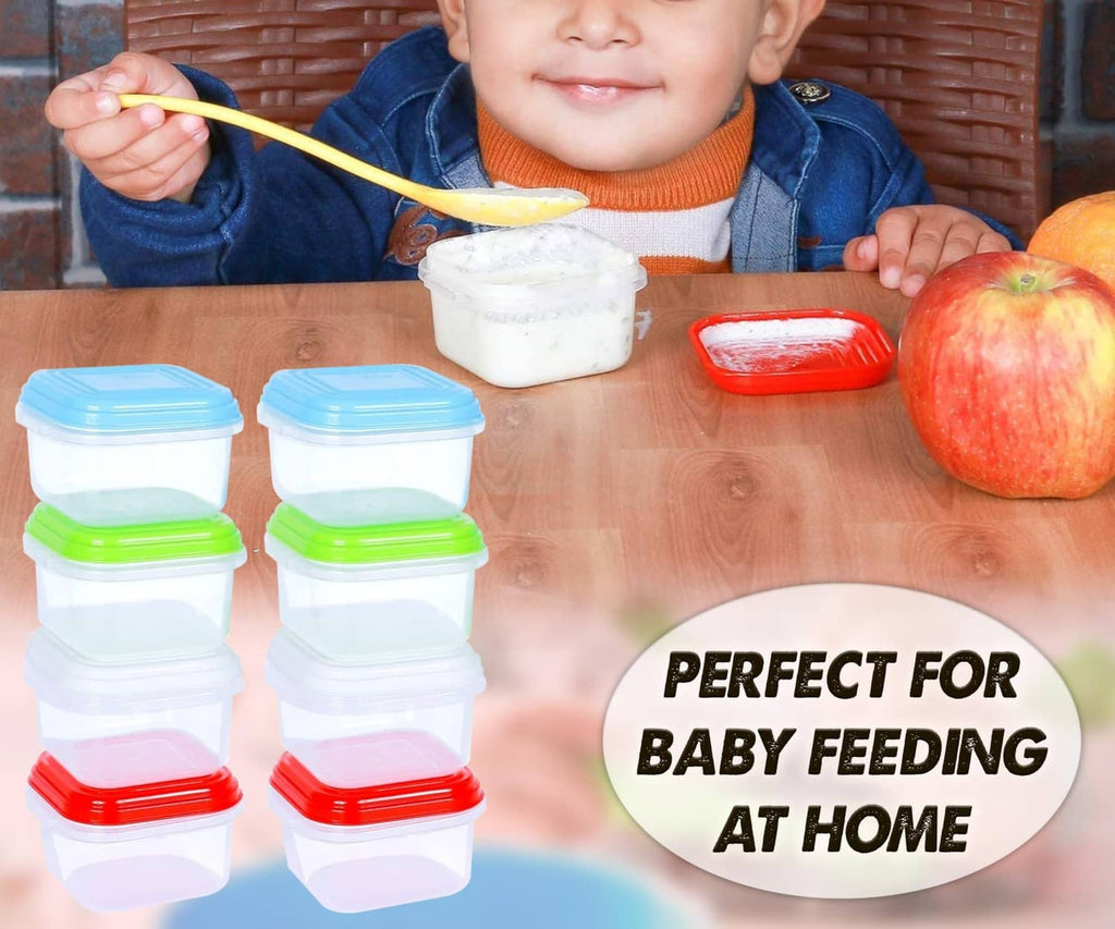 Stack of reusable baby food containers with blue, green, and red snap lids
