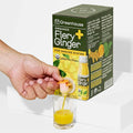 Organic cold-pressed fiery ginger immunity shot box with shot glass and hand pouring