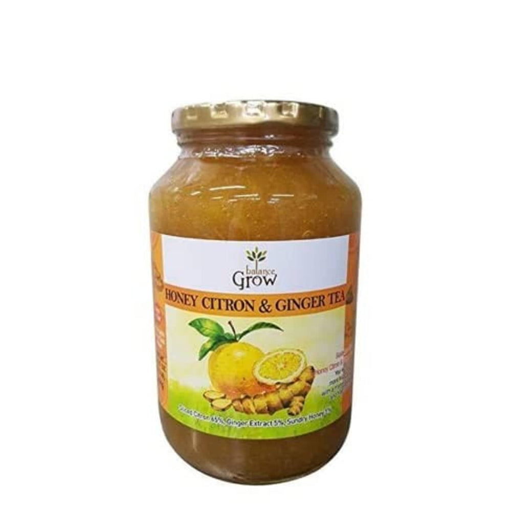 Honey citron & ginger tea jar with metal lid, brown honey liquid inside