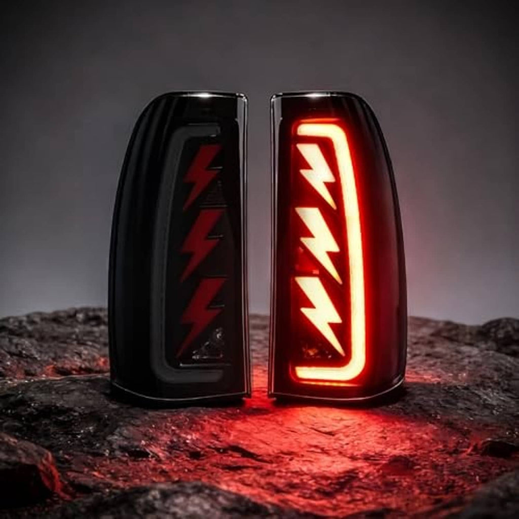 Two black LED tail lights with red sequential lightning-style light bar glowing