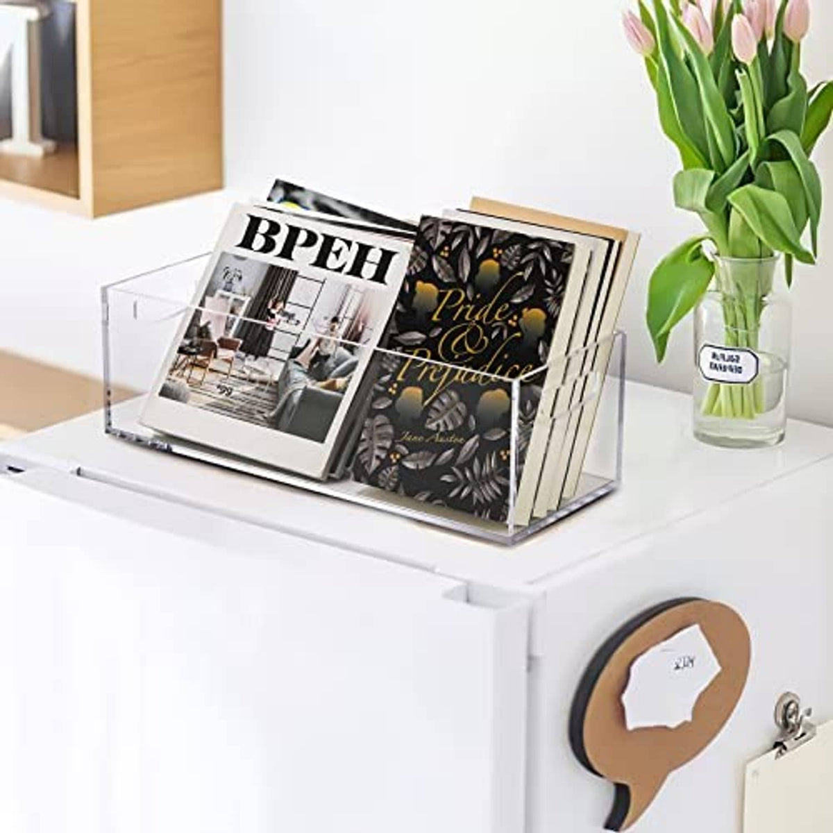 Clear acrylic storage box with handle, holding magazines or booklets
