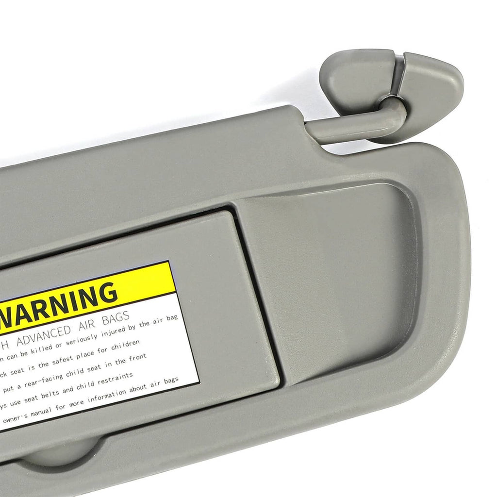 Close-up of grey sun visor with Air Bag warning label and pivot hinge