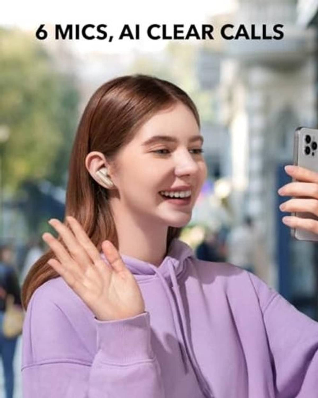 Oat-white wireless earbuds in-ear on a person with purple hoodie sleeves.