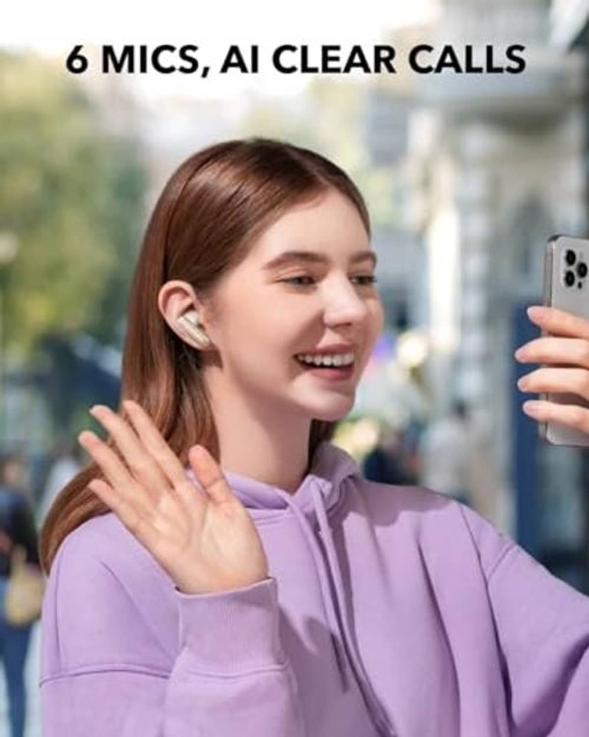 Oat-white wireless earbuds in-ear on a person with purple hoodie sleeves.