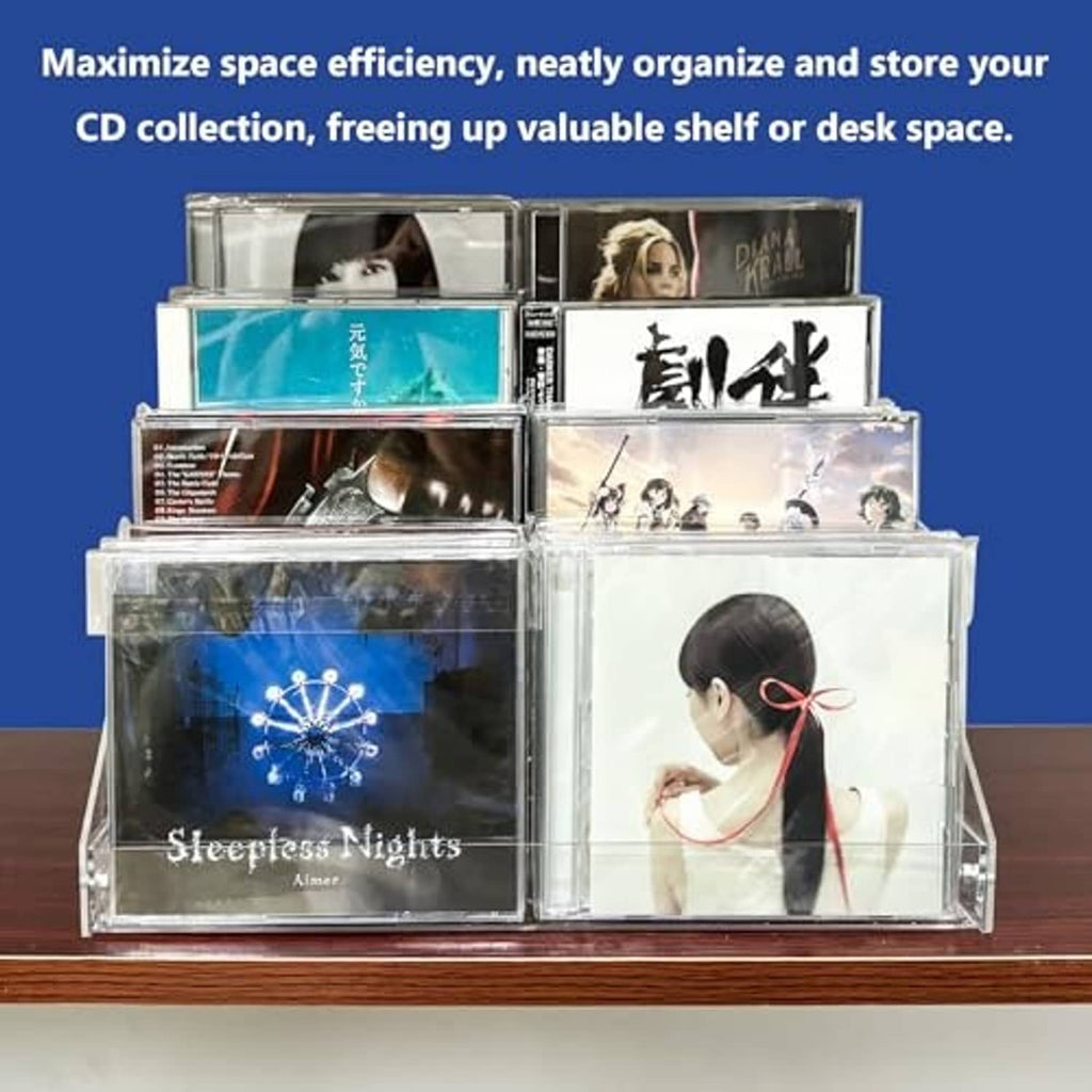 Clear acrylic 4-tier CD/DVD holder on tabletop with CDs arranged in cascading tiers