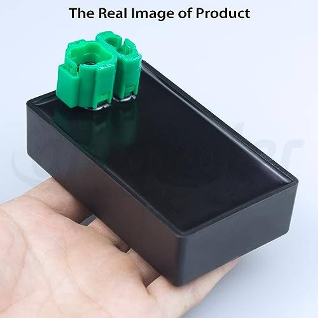 Ignition CDI module box held in hand, black case with green connector