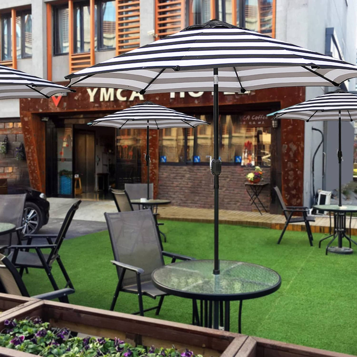 Striped patio umbrella with navy and white canopy and black lift pole