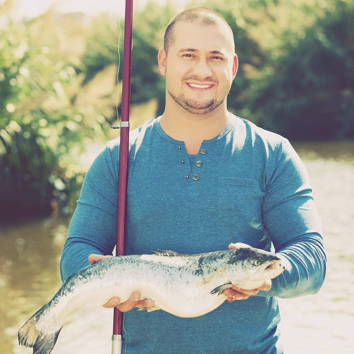 Tool storage box not visible; person holding a fishing rod and catch