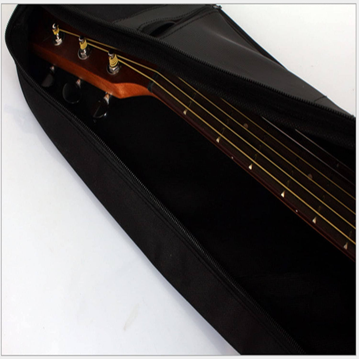 Black acoustic guitar bag interior with zipper and visible guitar headstock