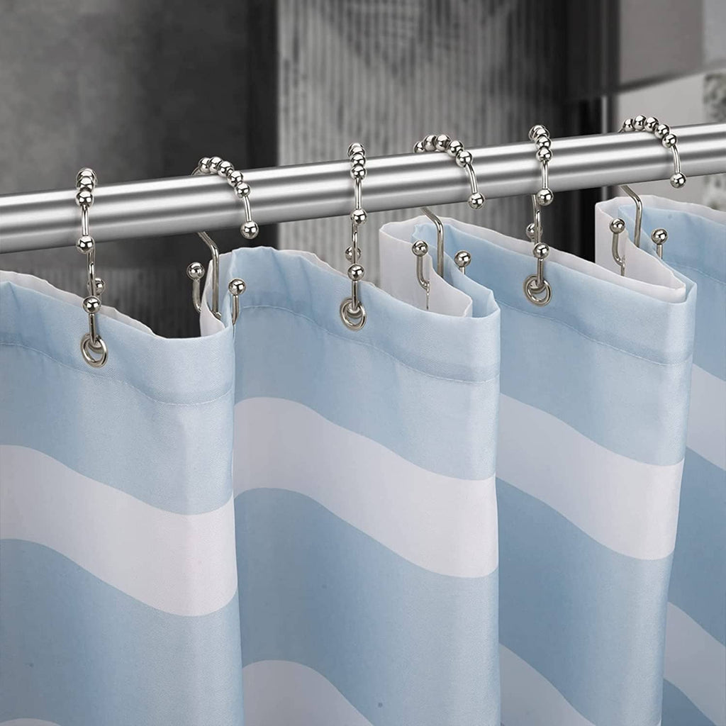 Blue shower liner panels hanging from metal shower curtain hook rings