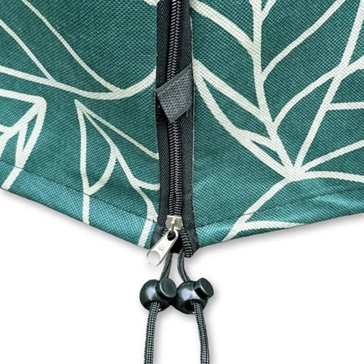 Green leaf-pattern plant cover fabric with black zipper closure and cord ties