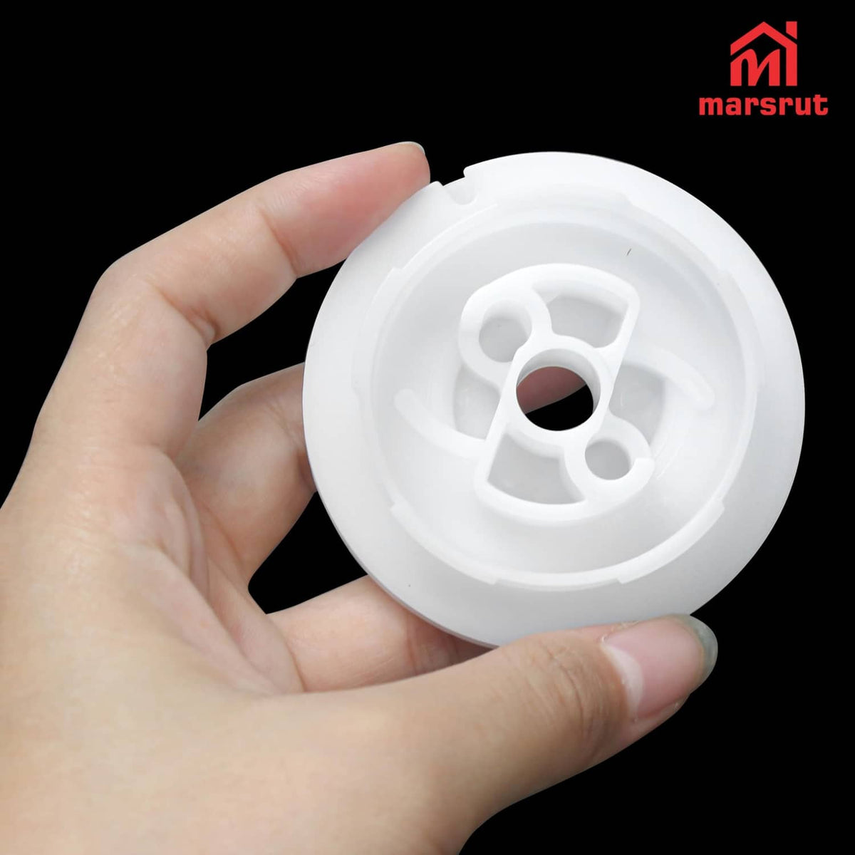 White recoil starter pulley with central hole, held in hand for size view
