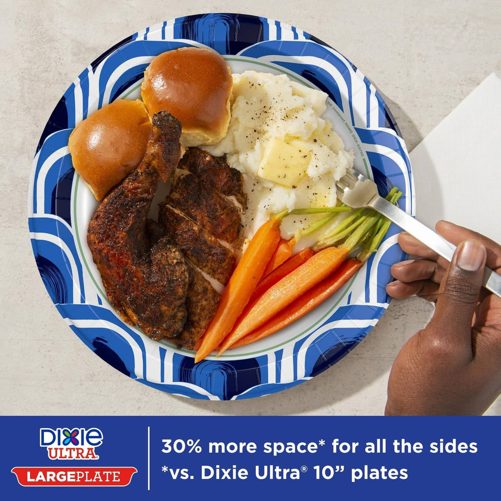 Blue-and-white patterned large paper plate with bread rolls, carrots, and greens