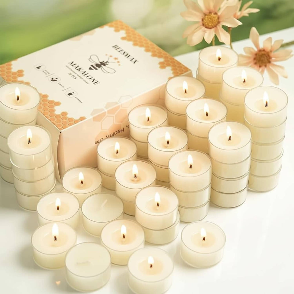 Cream beeswax tea light candles in metal cups, multiple wicks lit