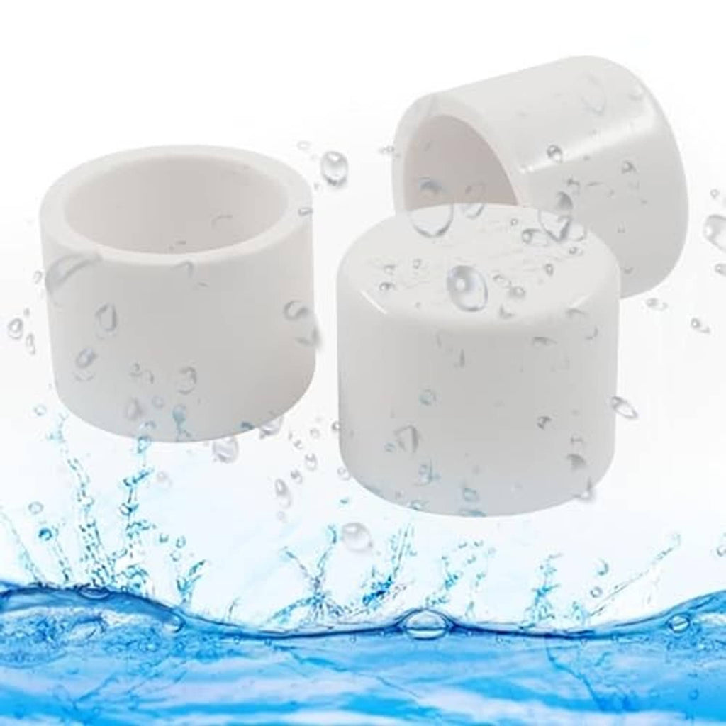 White PVC pipe end caps with water splash effect around open ends