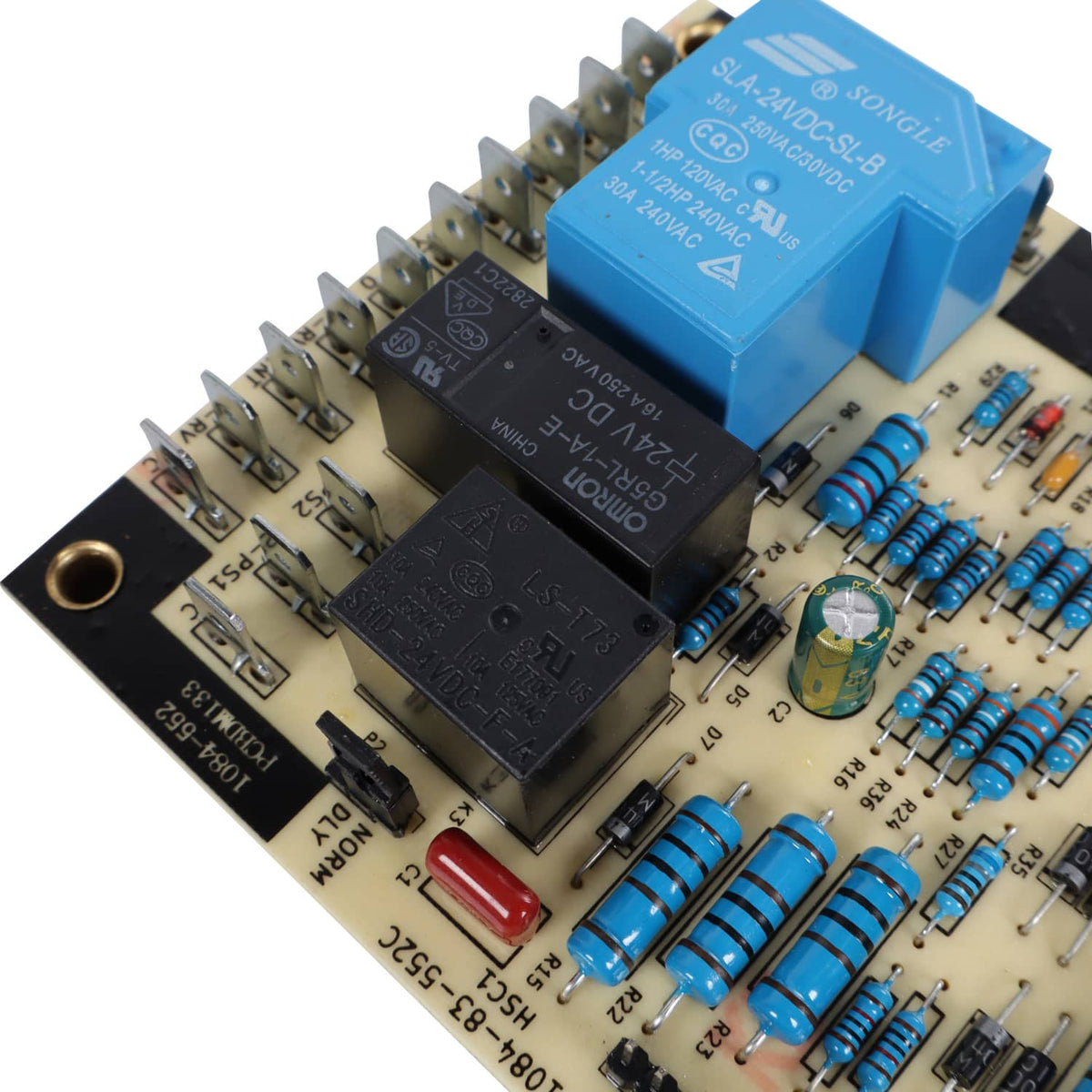 Heat pump defrost board close-up with blue relay, capacitors, and resistors