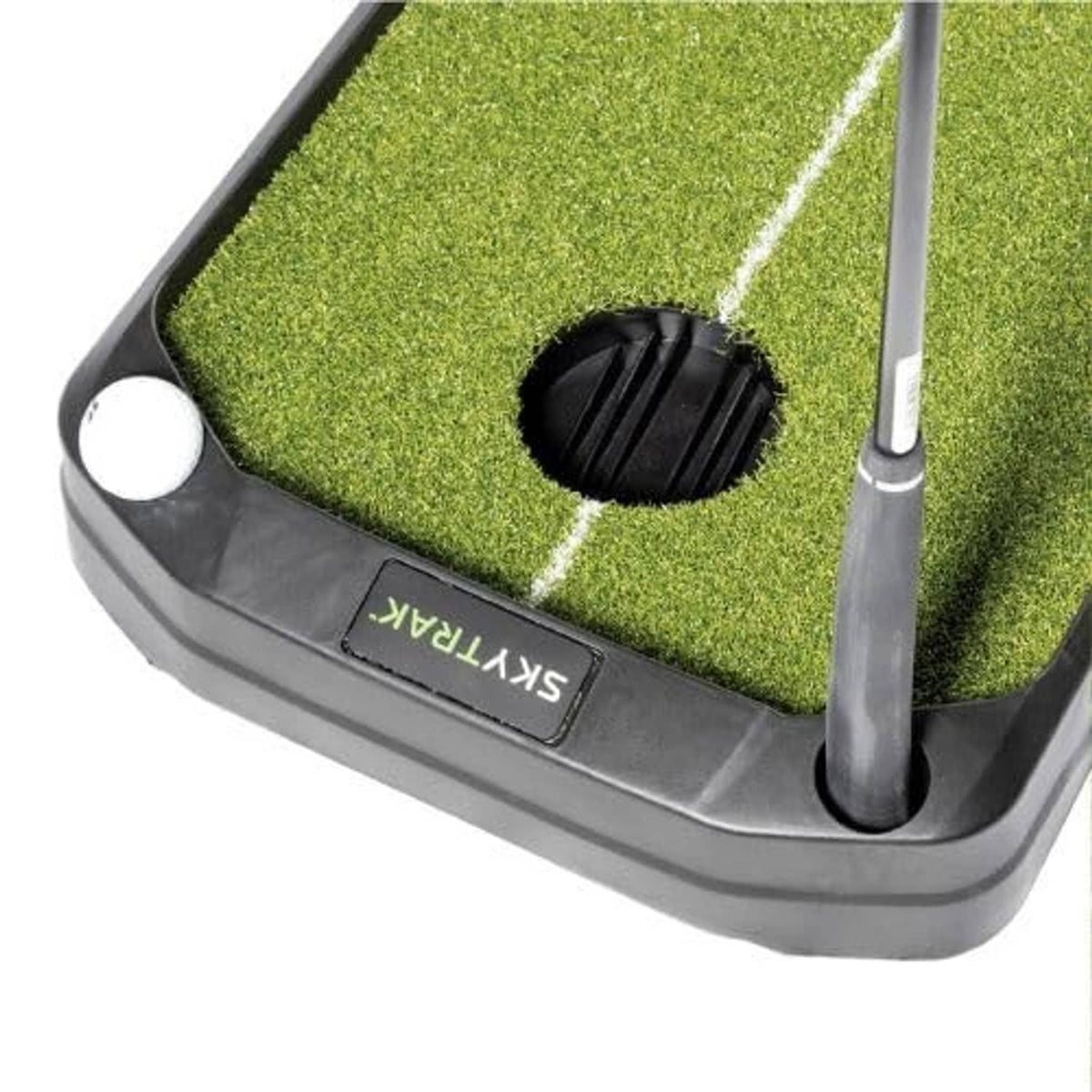 Corner view of ball return device on green turf with white guide lines