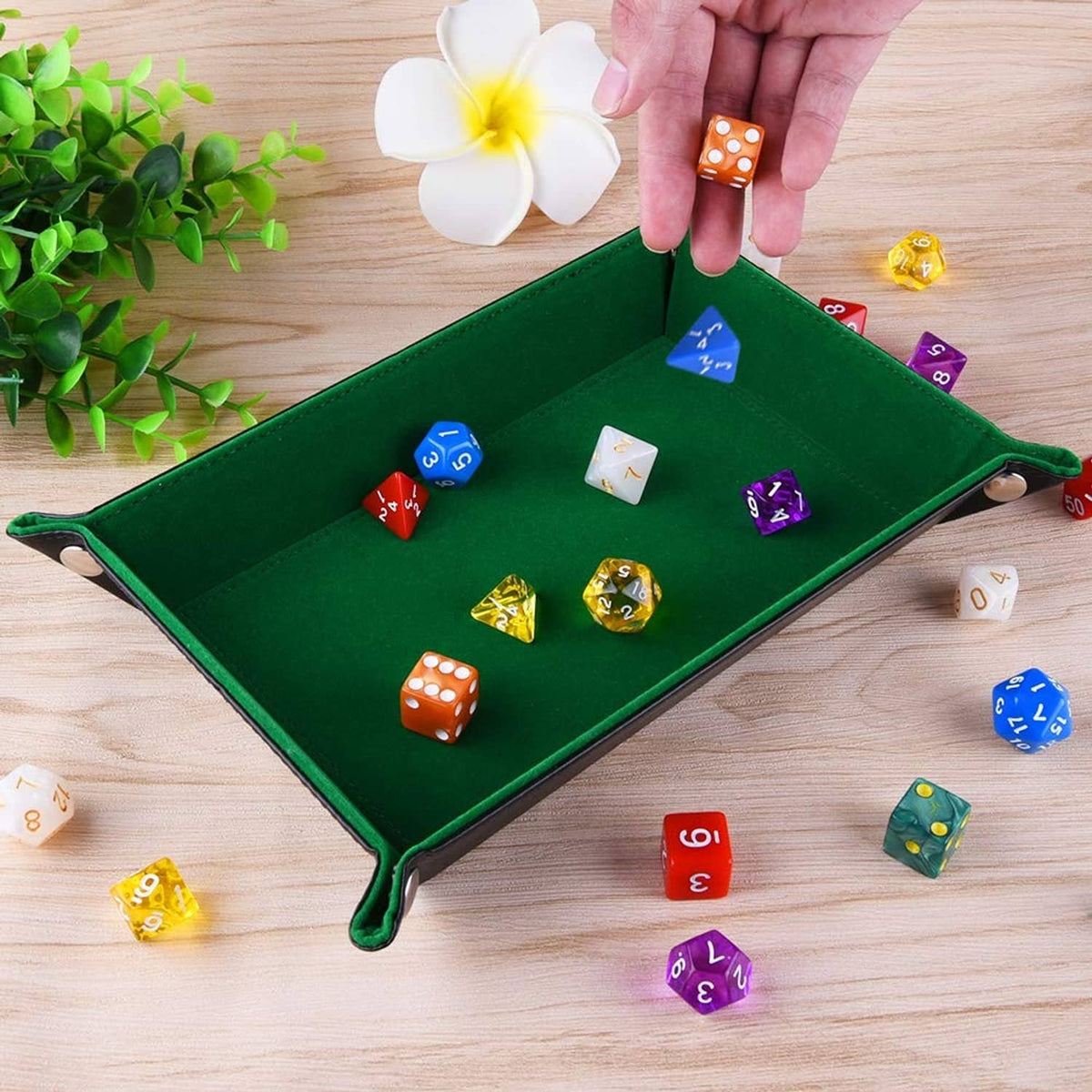 Green folding dice tray with metal snap corners, with polyhedral dice inside
