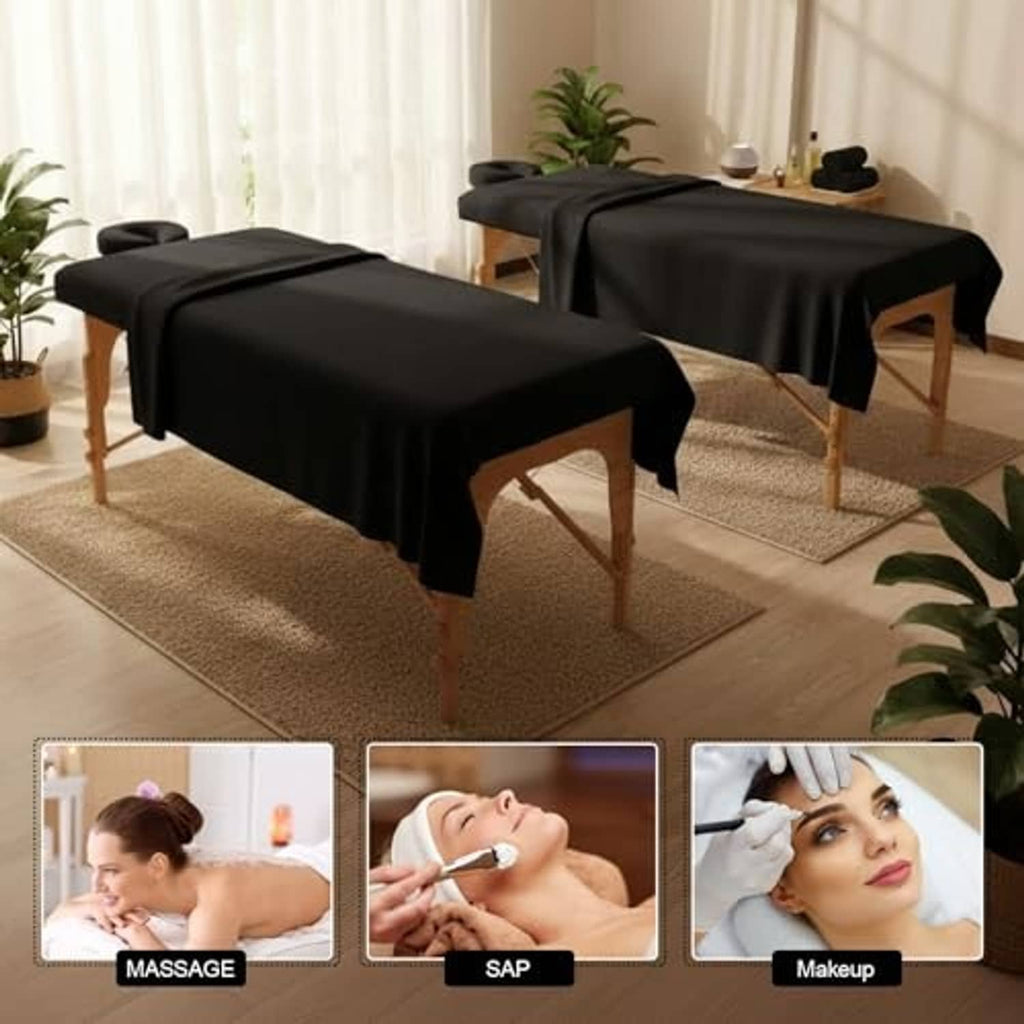 Set of black massage table sheets covering two massage tables for spa use