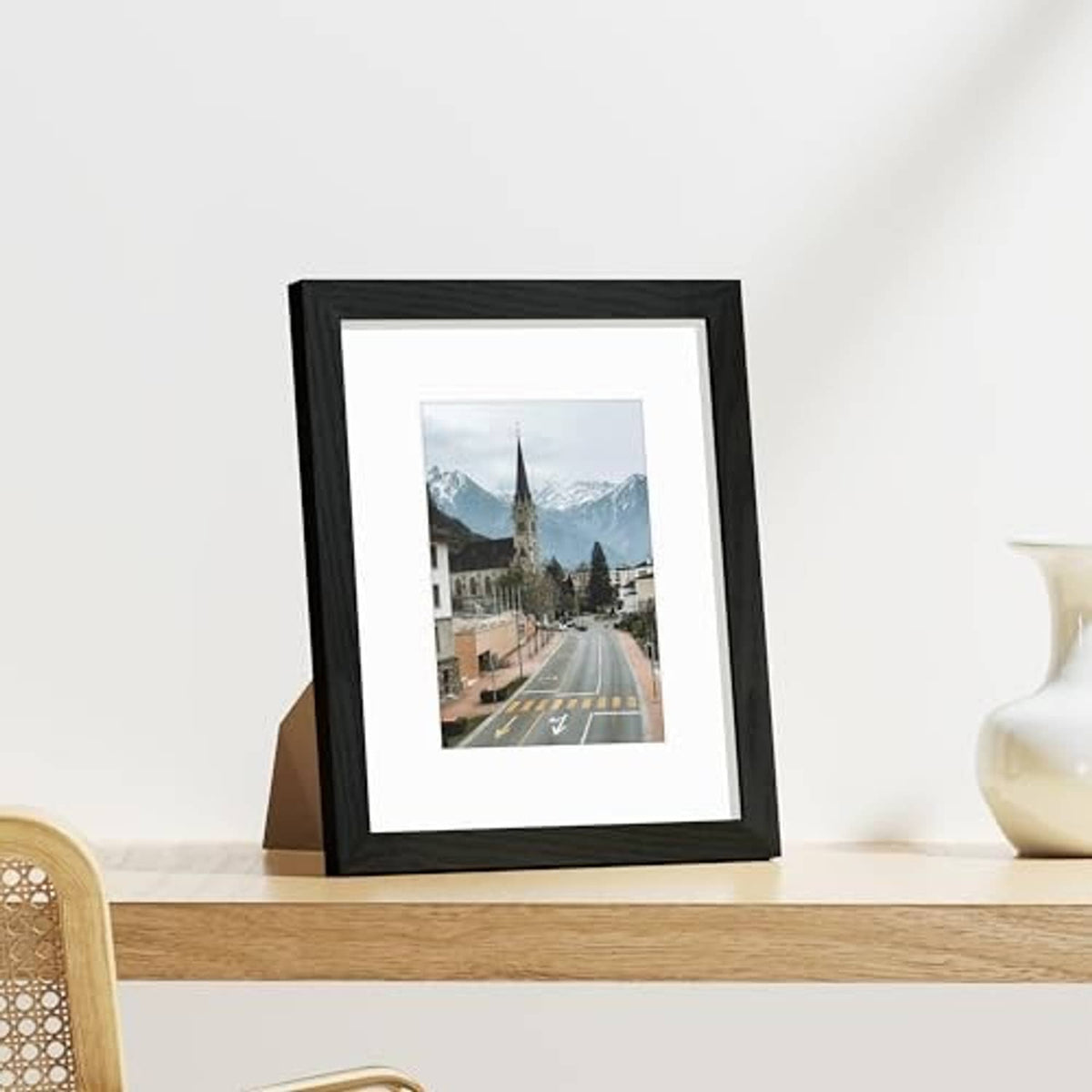 Single black picture frame with white mat and clear plexiglass front, landscape photo