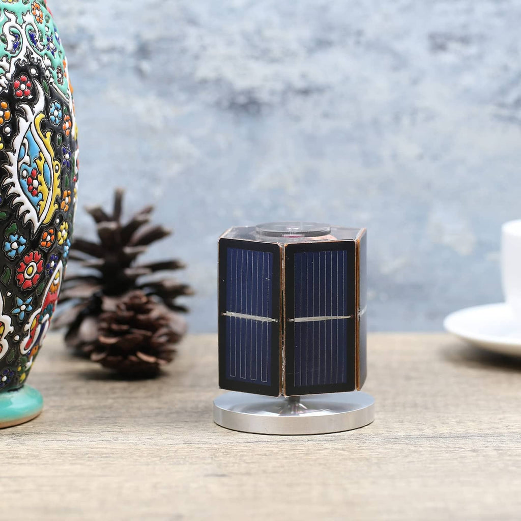 Solar motor toy on a round stand, blue solar panel cube with front crossbar detail