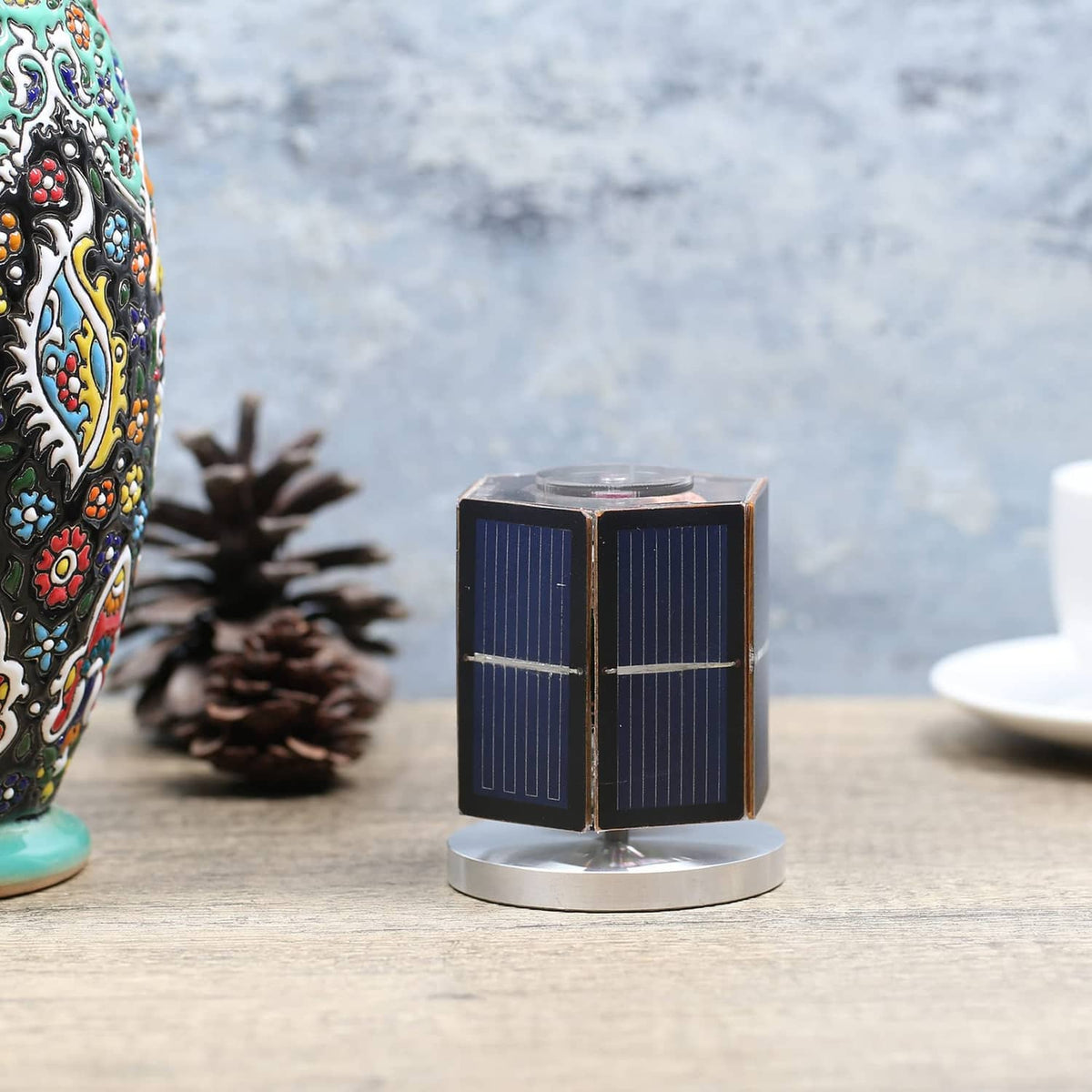Solar motor toy on a round stand, blue solar panel cube with front crossbar detail