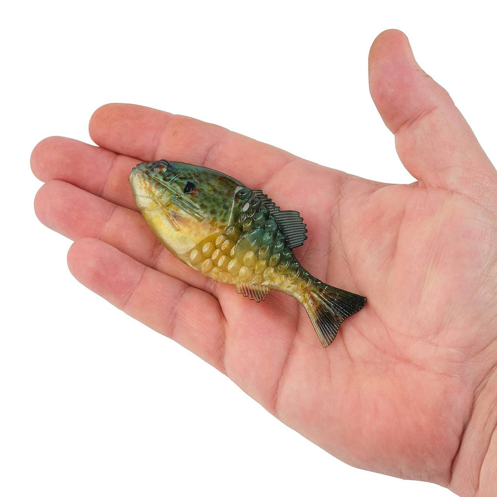 Green and yellow gilly-style soft plastic fishing lure held in palm, detailed scales