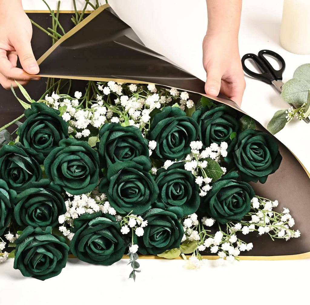 Dark green fake rose bouquet with small white filler flowers, held in a wrapping sheet