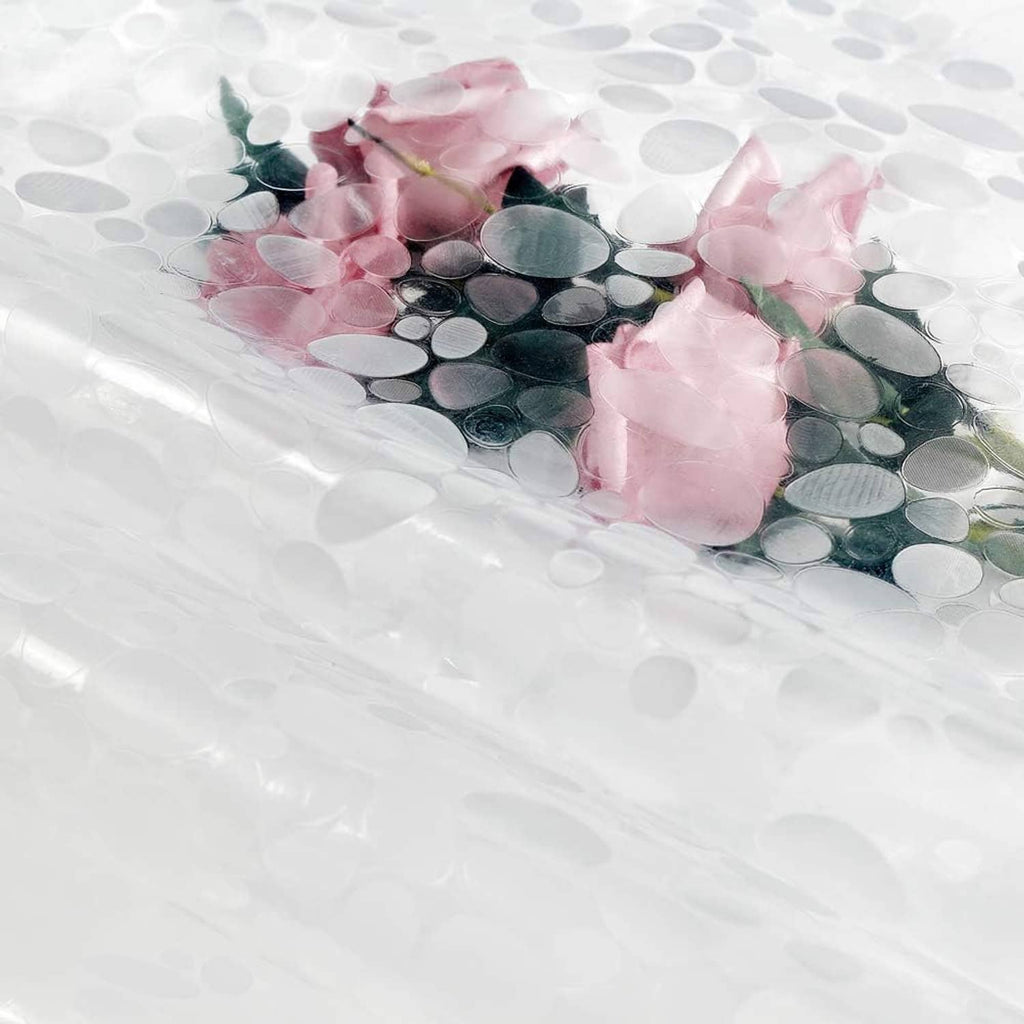 Clear shower curtain liner with circular magnets and pink flower accents near bottom