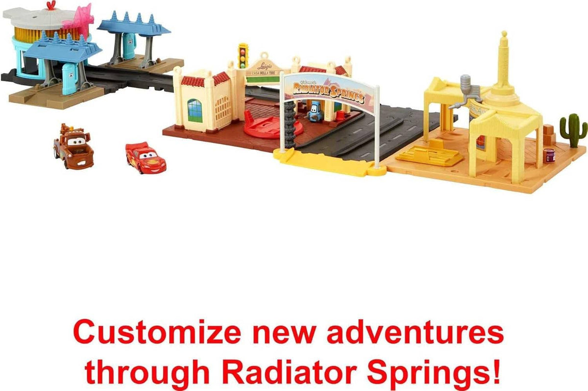 Cars track playset with towers, gate, ramp, and two toy cars for customization