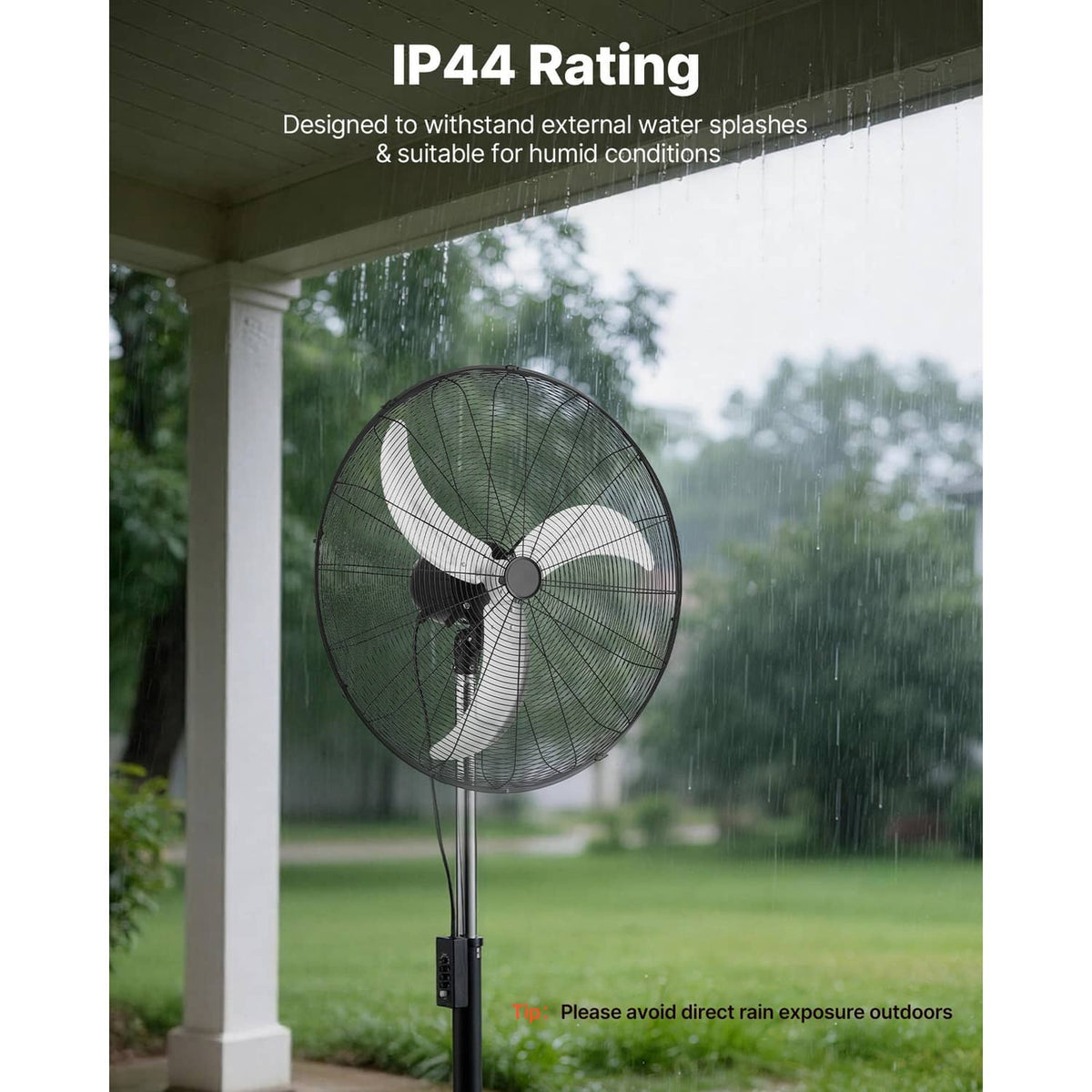 Industrial pedestal fan with black grille and pole standing in rainy conditions for outdoor use