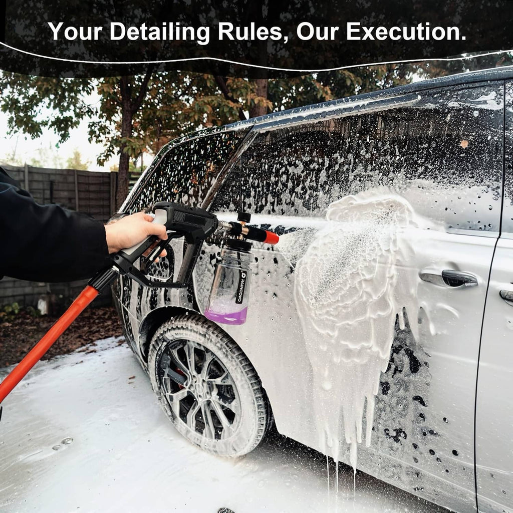 Foam cannon dispensing white foam from a black handle and red nozzle tube