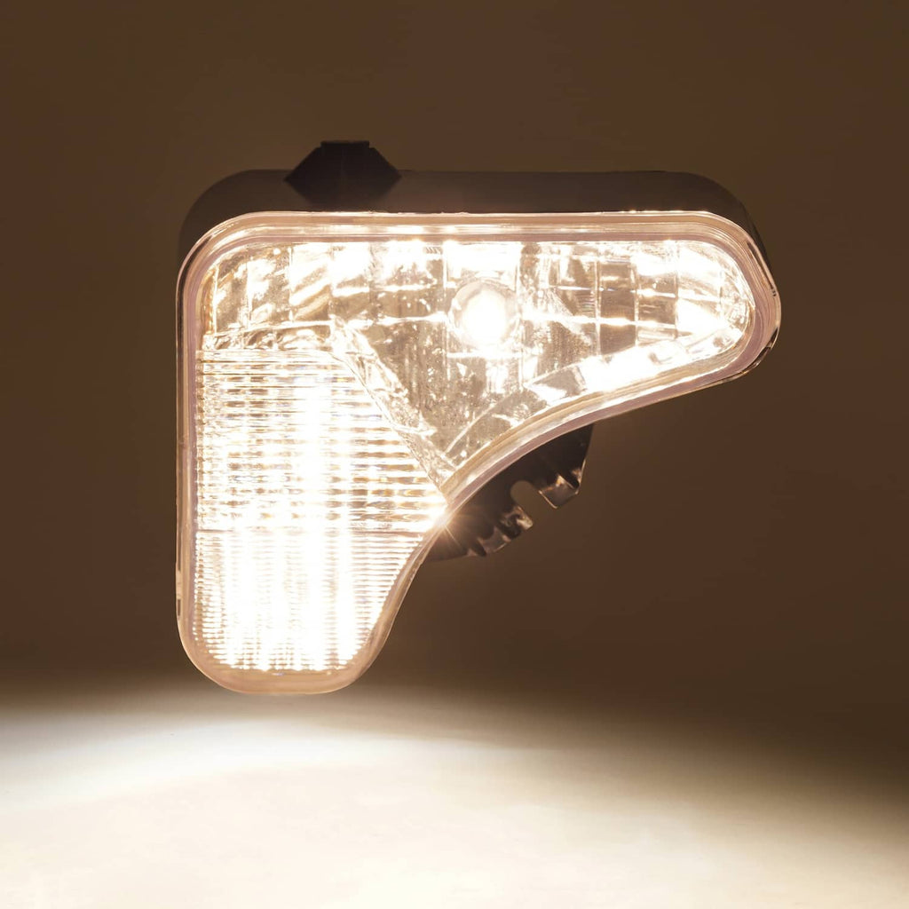 Right headlight lamp with clear lens and ridged reflector, black mounting bracket