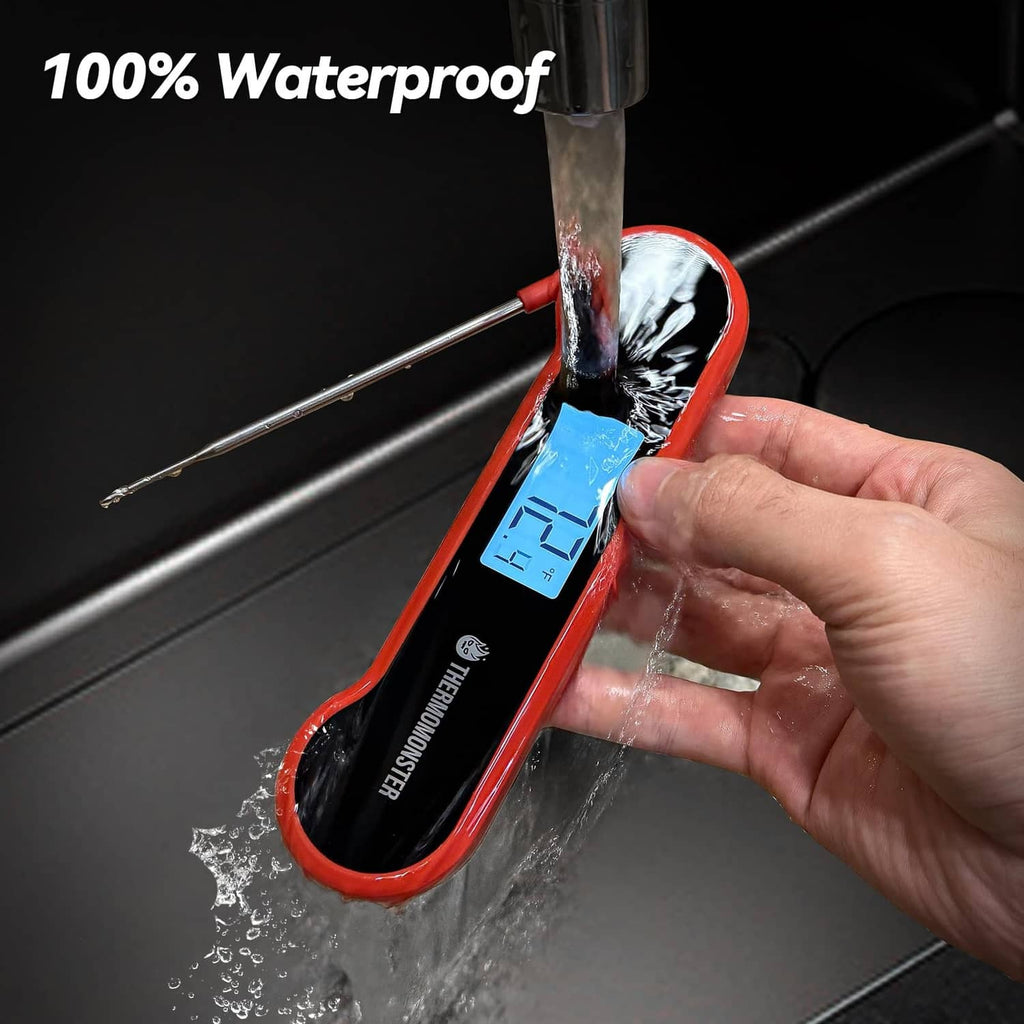 Red waterproof meat thermometer in running water, blue LCD screen visible