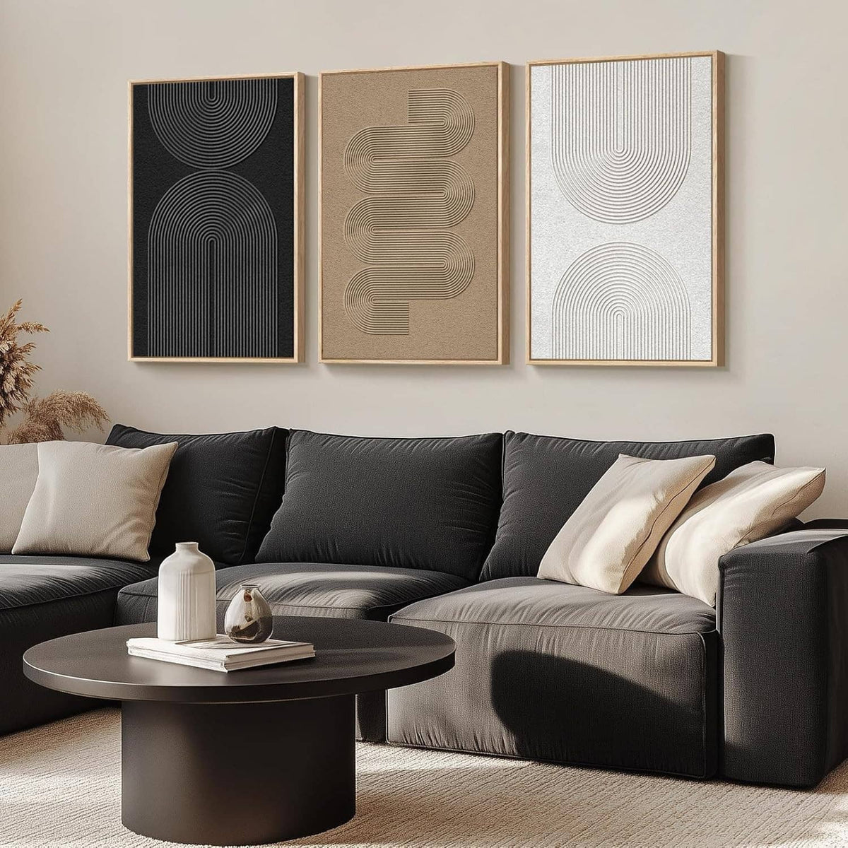 Three framed abstract line art panels in black, beige, and light gray above sofa