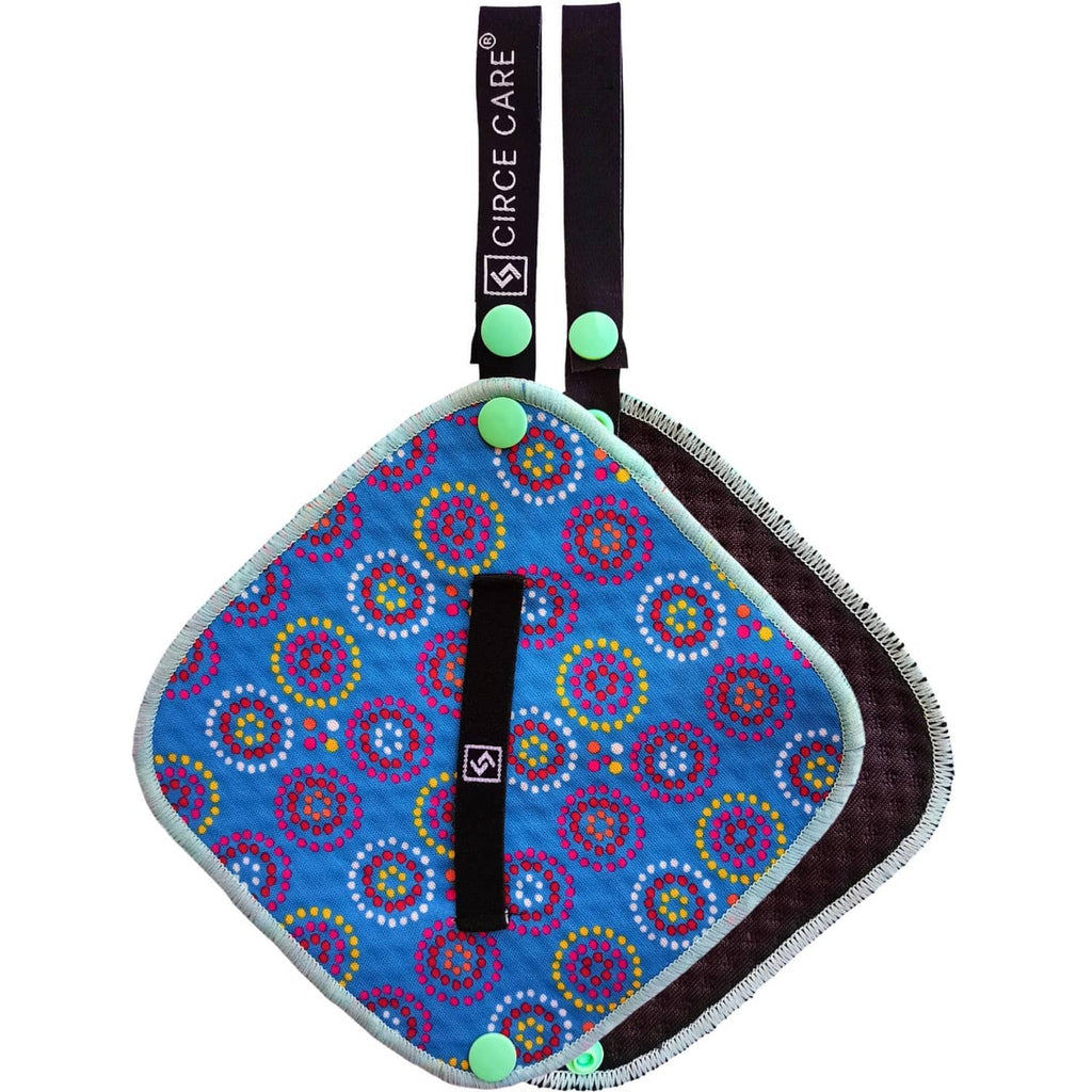 Blue patterned pee cloth with black strap and green snap; silver-infused fabric