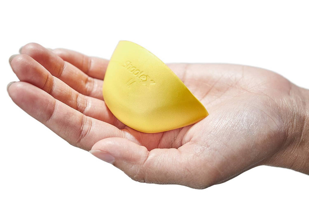 Yellow shoe filler insert held in hand, M size