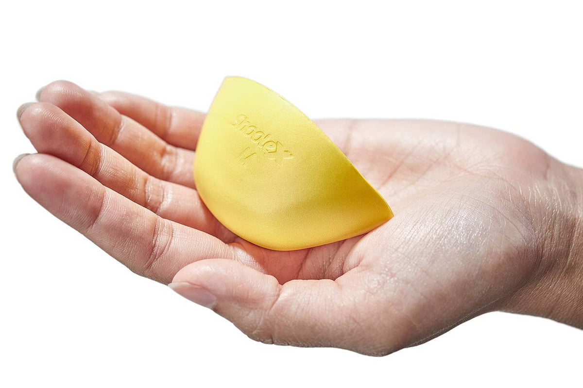 Yellow shoe filler insert held in hand, M size