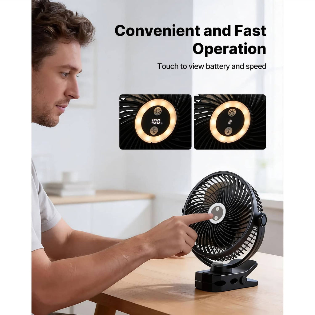 Clip fan with glowing control dial, adjusted by hand on a tabletop
