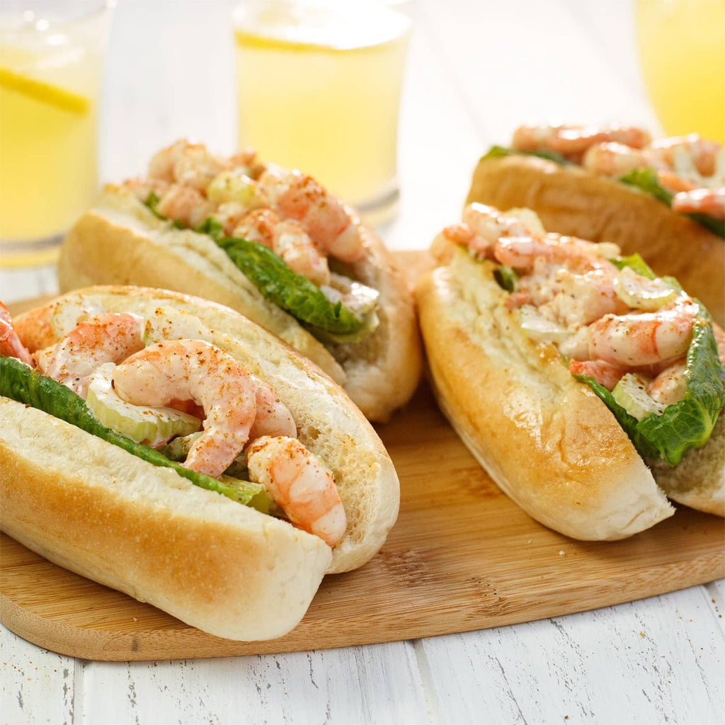 Shrimp-filled buns with green herb garnish and lettuce