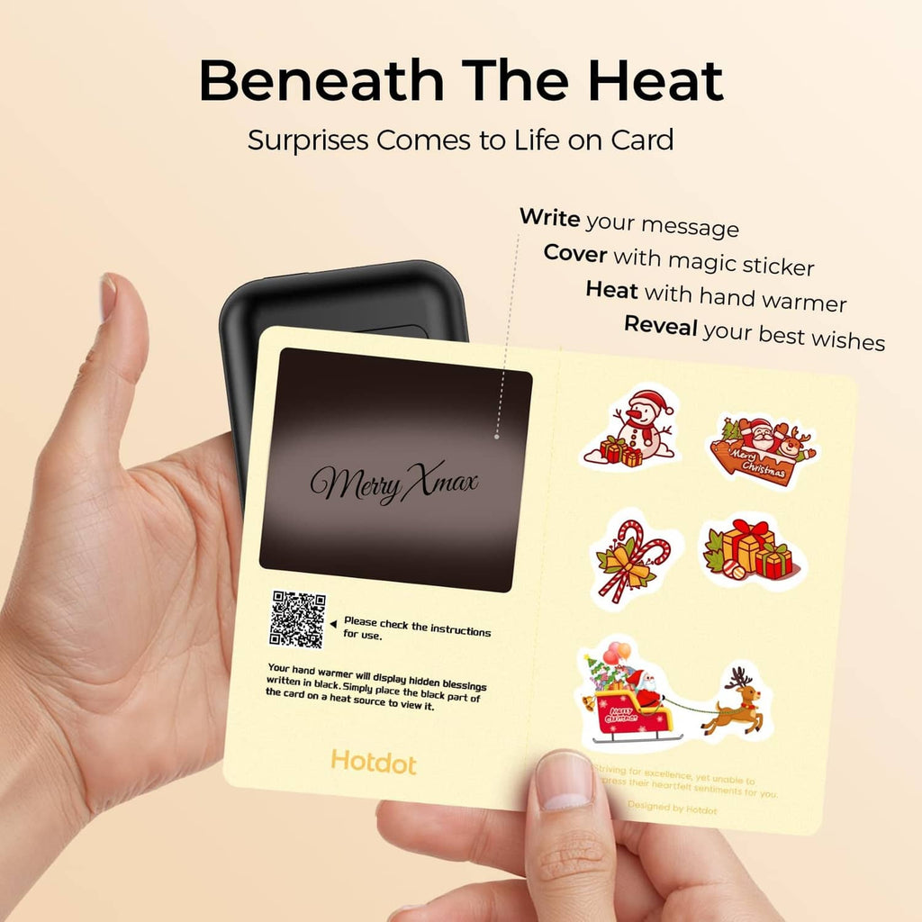 Black hand warmer with blessing card held in hands, featuring holiday-style stickers.