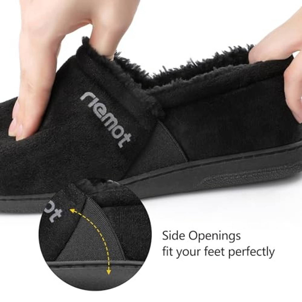 Black moccasin slippers close-up with side opening and fuzzy lining detail.