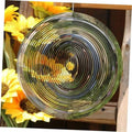 Silver round wind spinner with concentric metal rings and central hanging bead