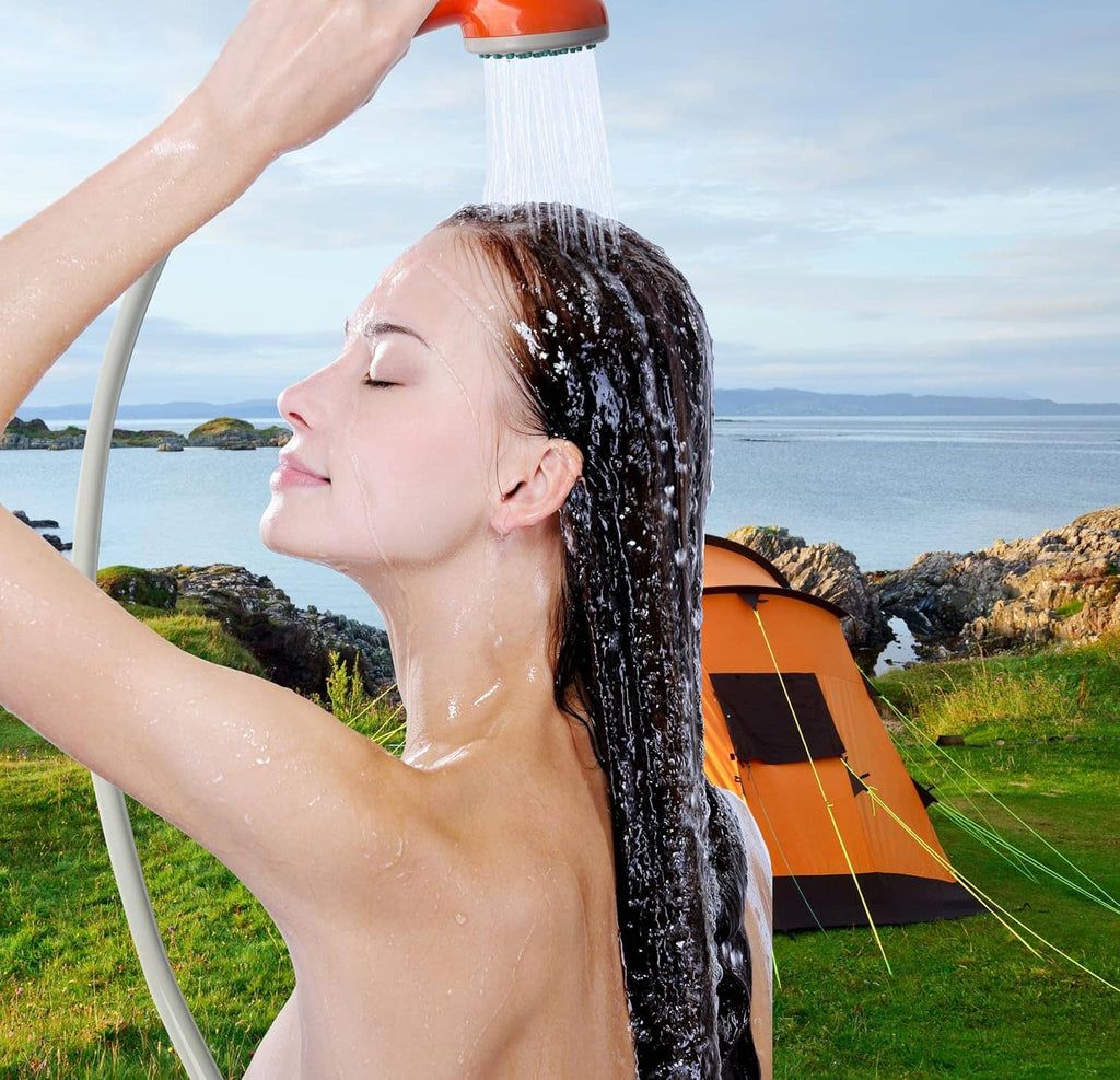 Handheld portable shower spraying water from orange shower head