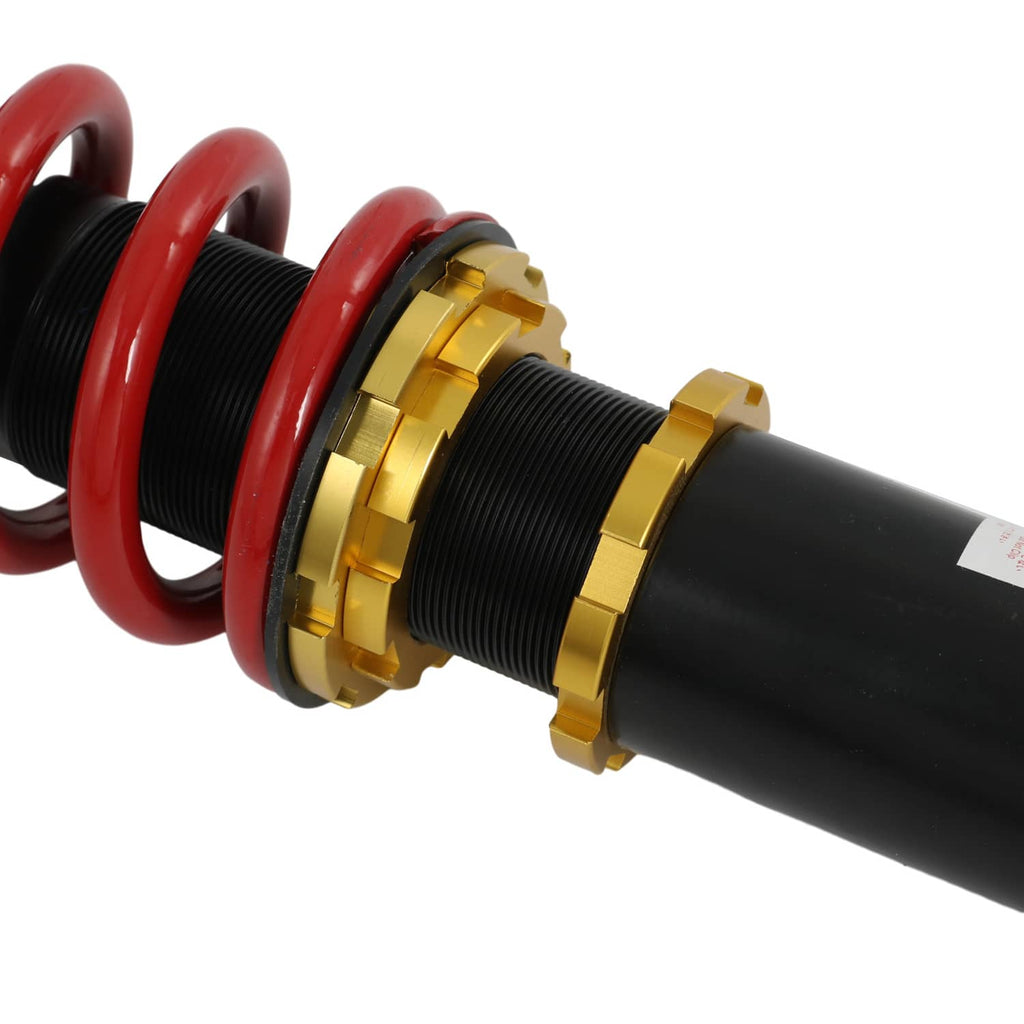 Close-up of gold adjustment collars and red spring around threaded coilover tube