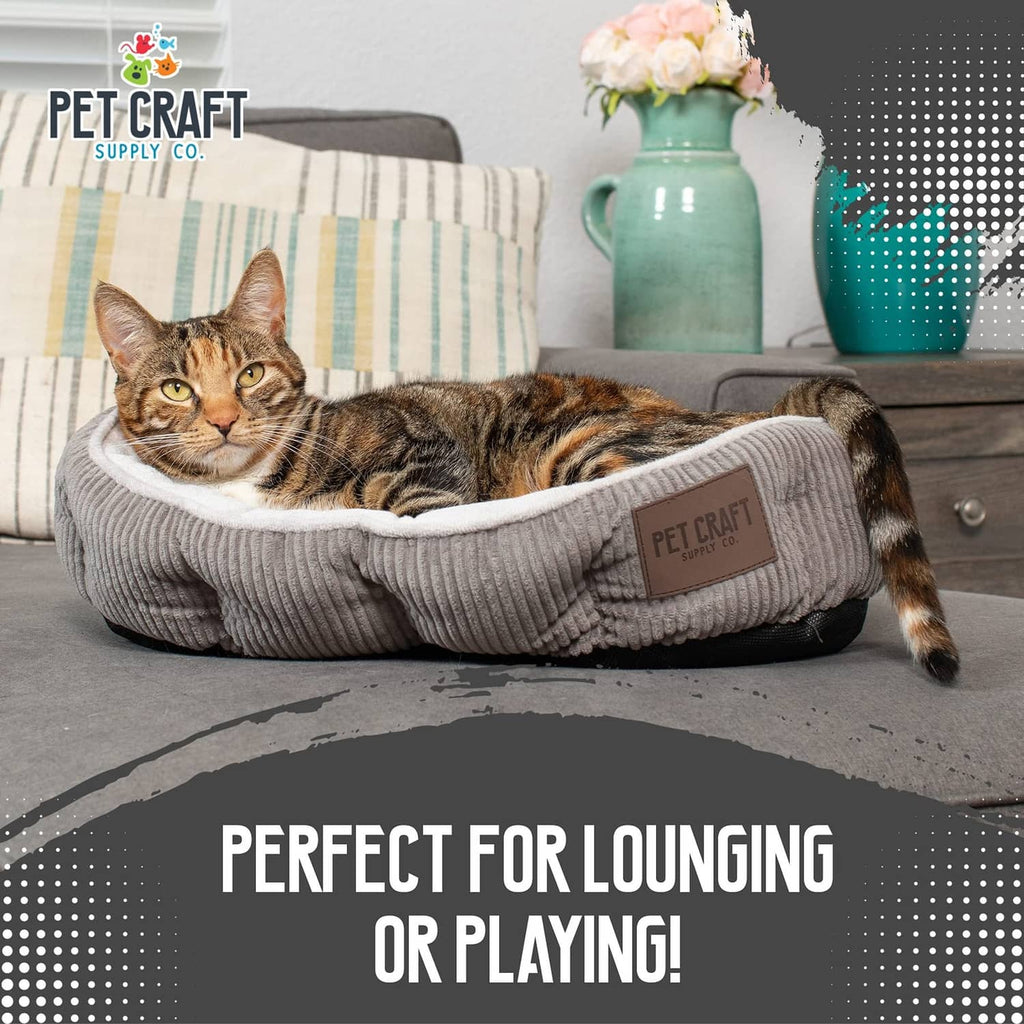 Gray ribbed cat bed with plush edge; tabby cat lounging inside