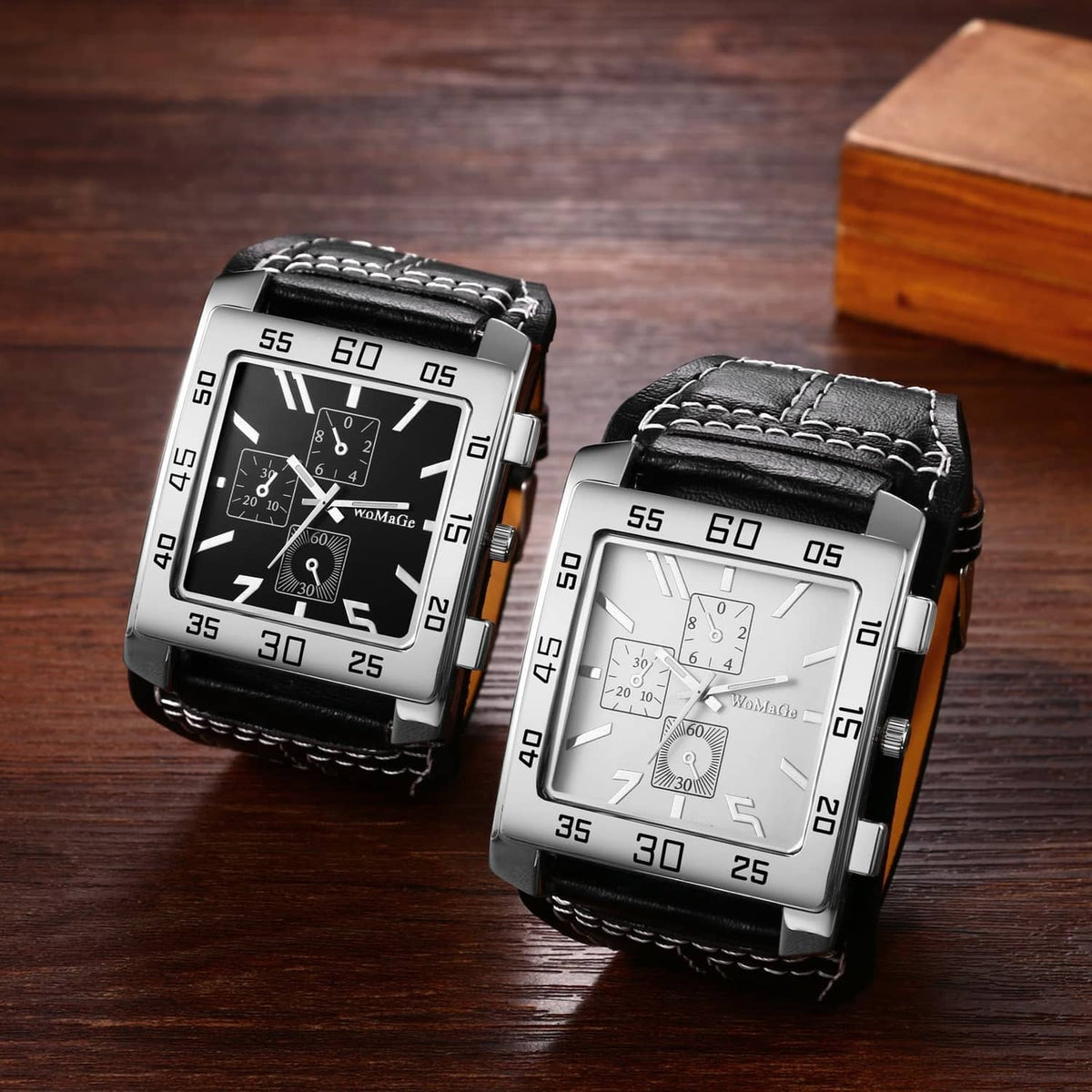 Two square wristwatches with black dials and silver cases, black leather straps shown