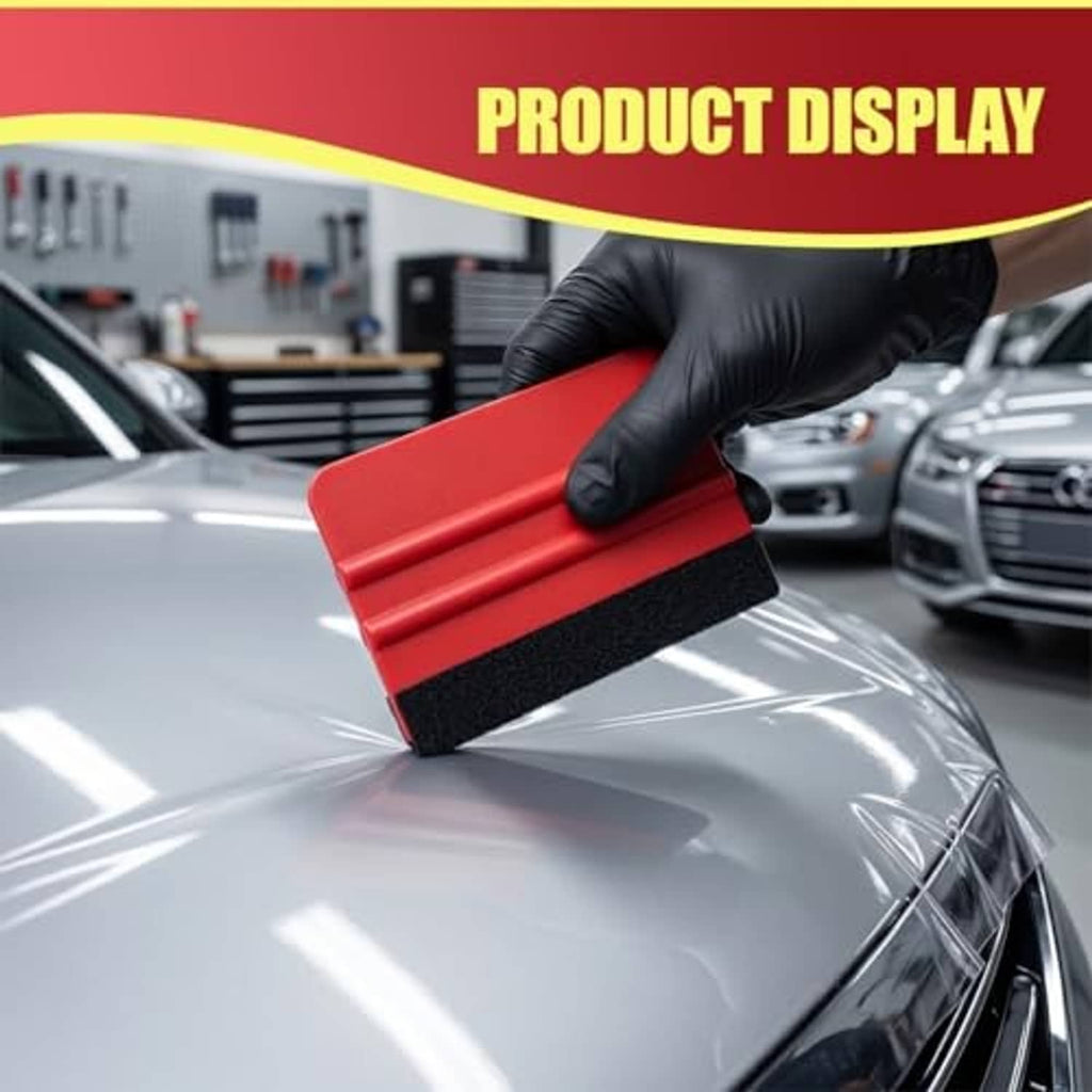 Red plastic felt-edge squeegee applying pressure on a glossy vehicle surface