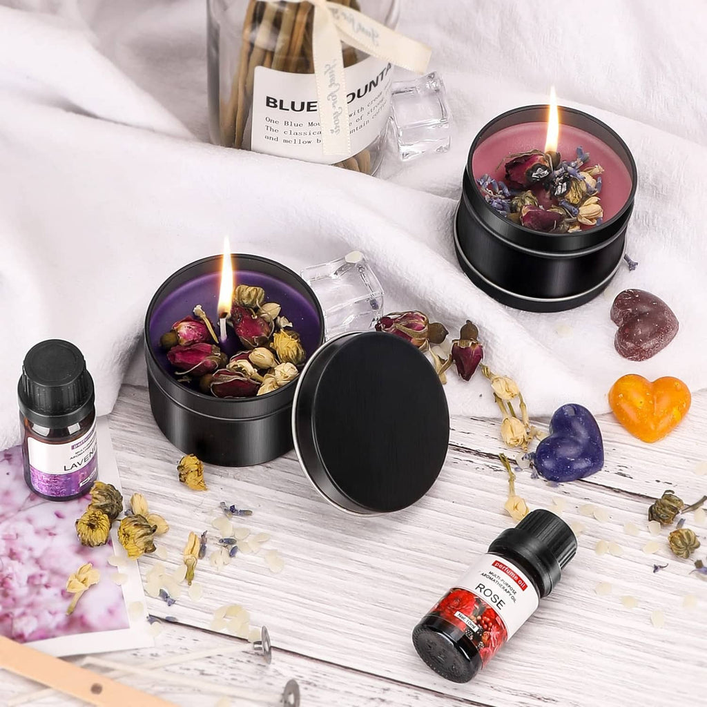 Wax melter candle jars with rose and lavender oil bottles, dried flowers and wax cubes